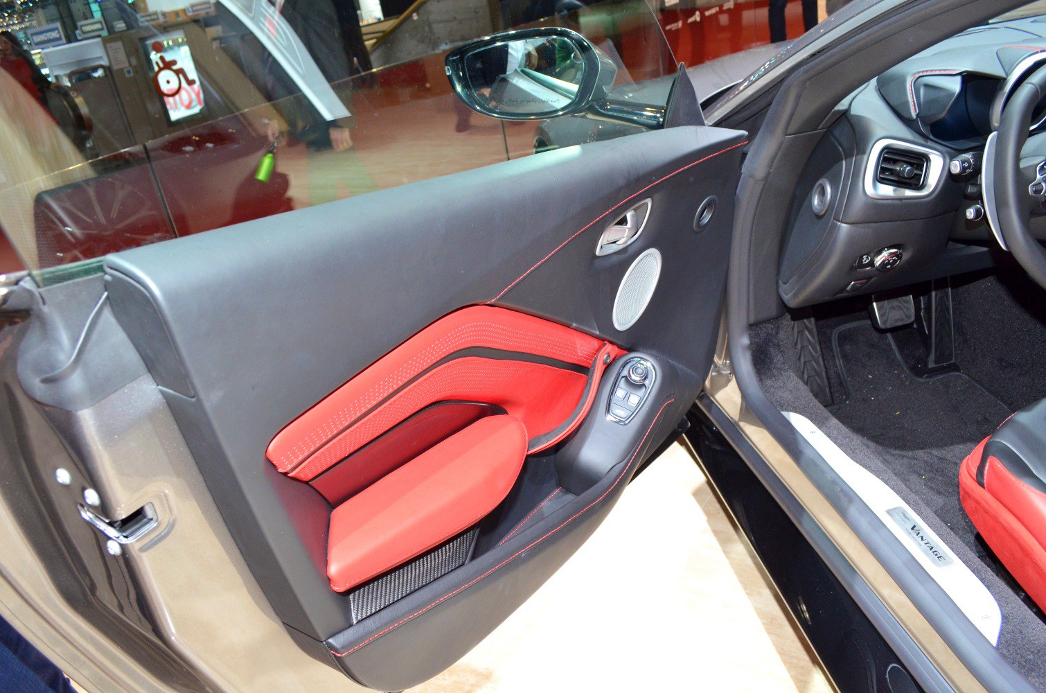 Red and black interior door panel with controls and speaker