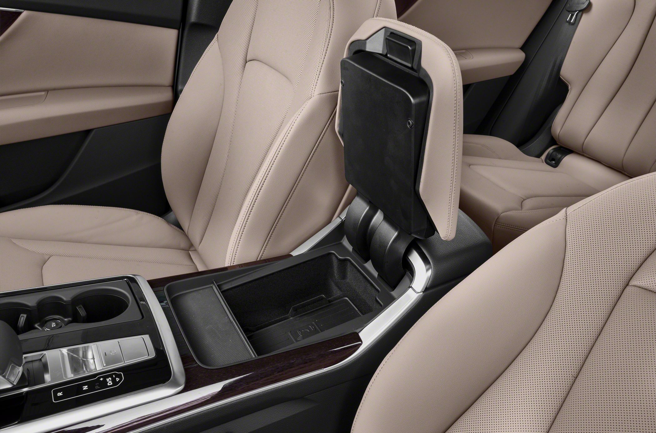 Center console storage with cup holders and beige leather seats