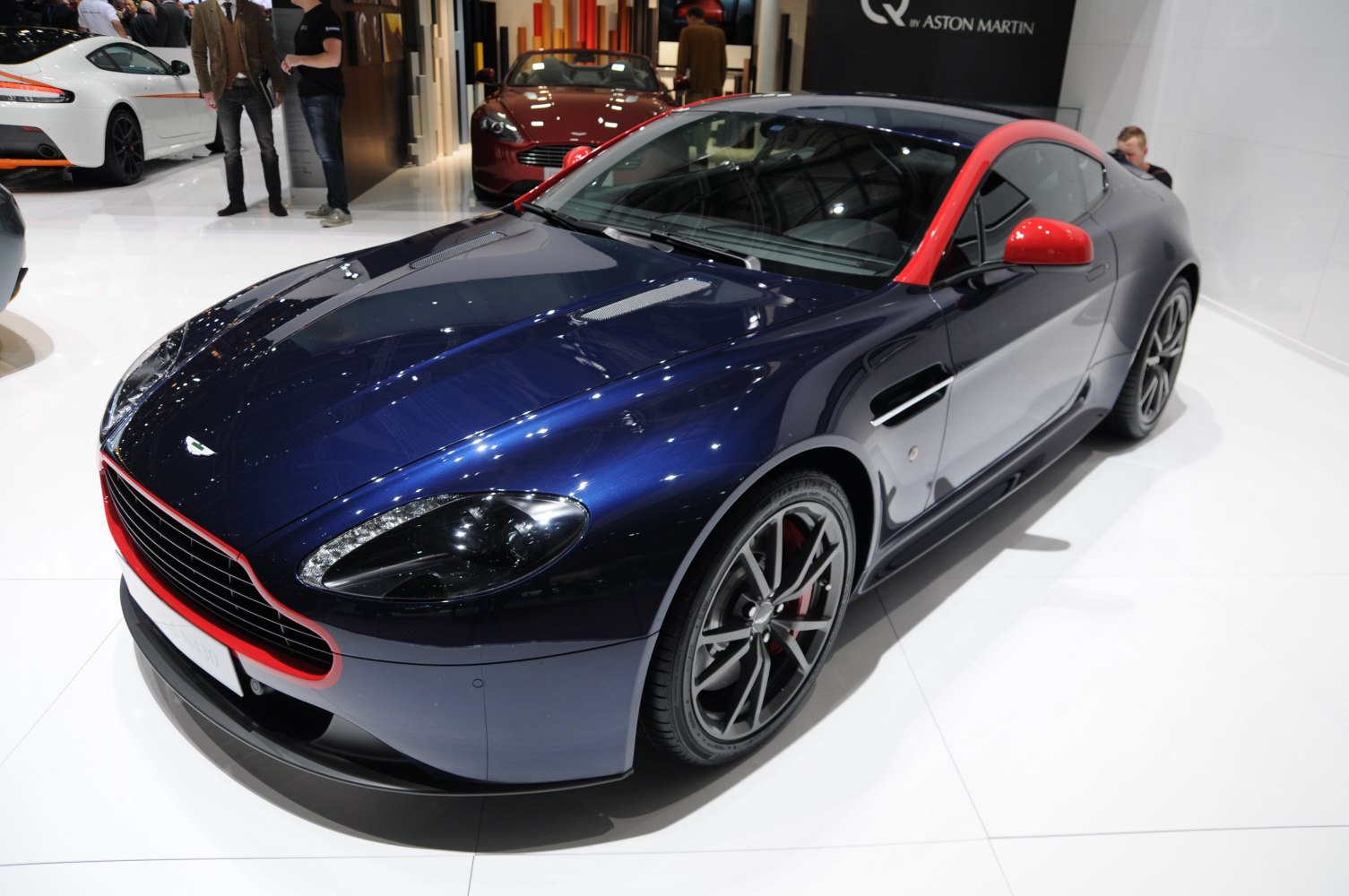 Blue Aston Martin V8 Vantage with red accents and sporty alloy wheels
