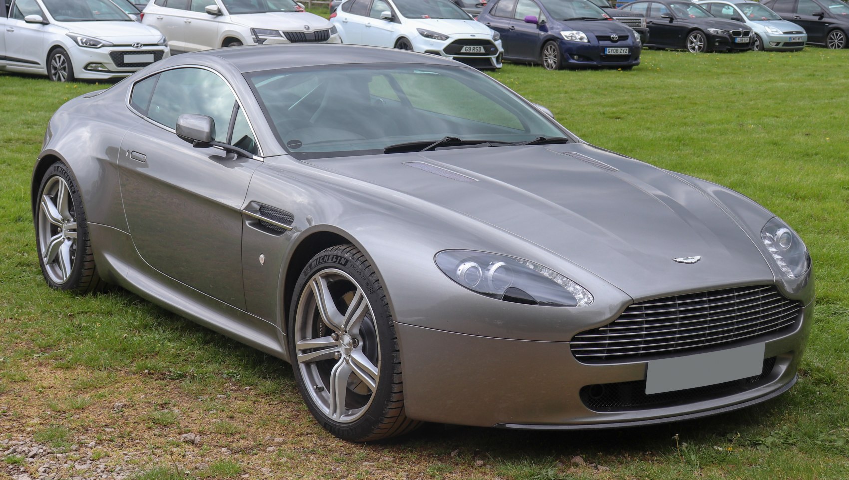 Silver sports coupe with front grille and distinctive headlights