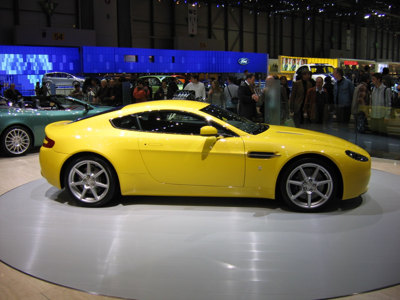 Yellow sports coupe showing side profile with alloy wheels