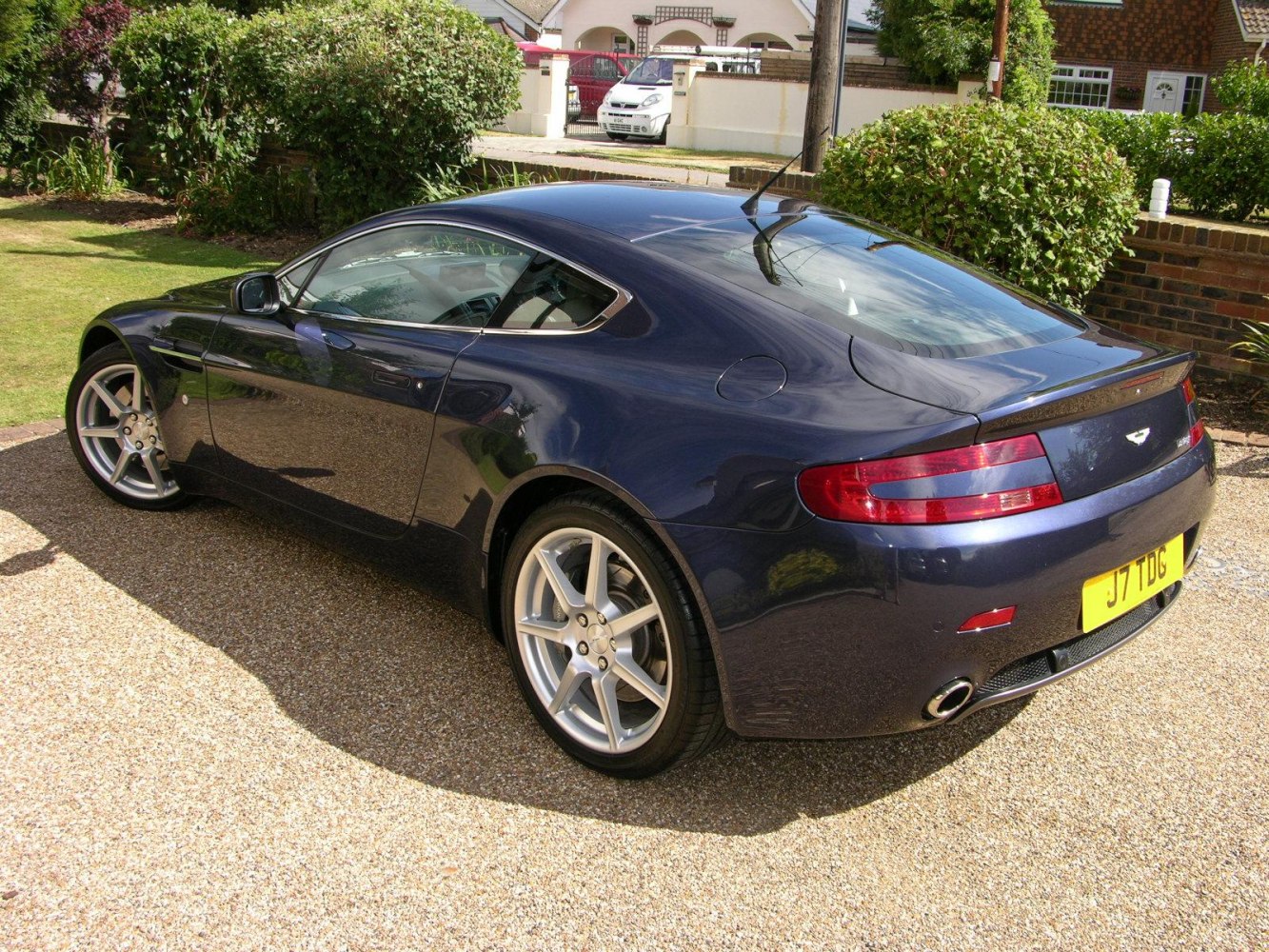 Rear and side profile of a sleek luxury coupe with alloy wheels.