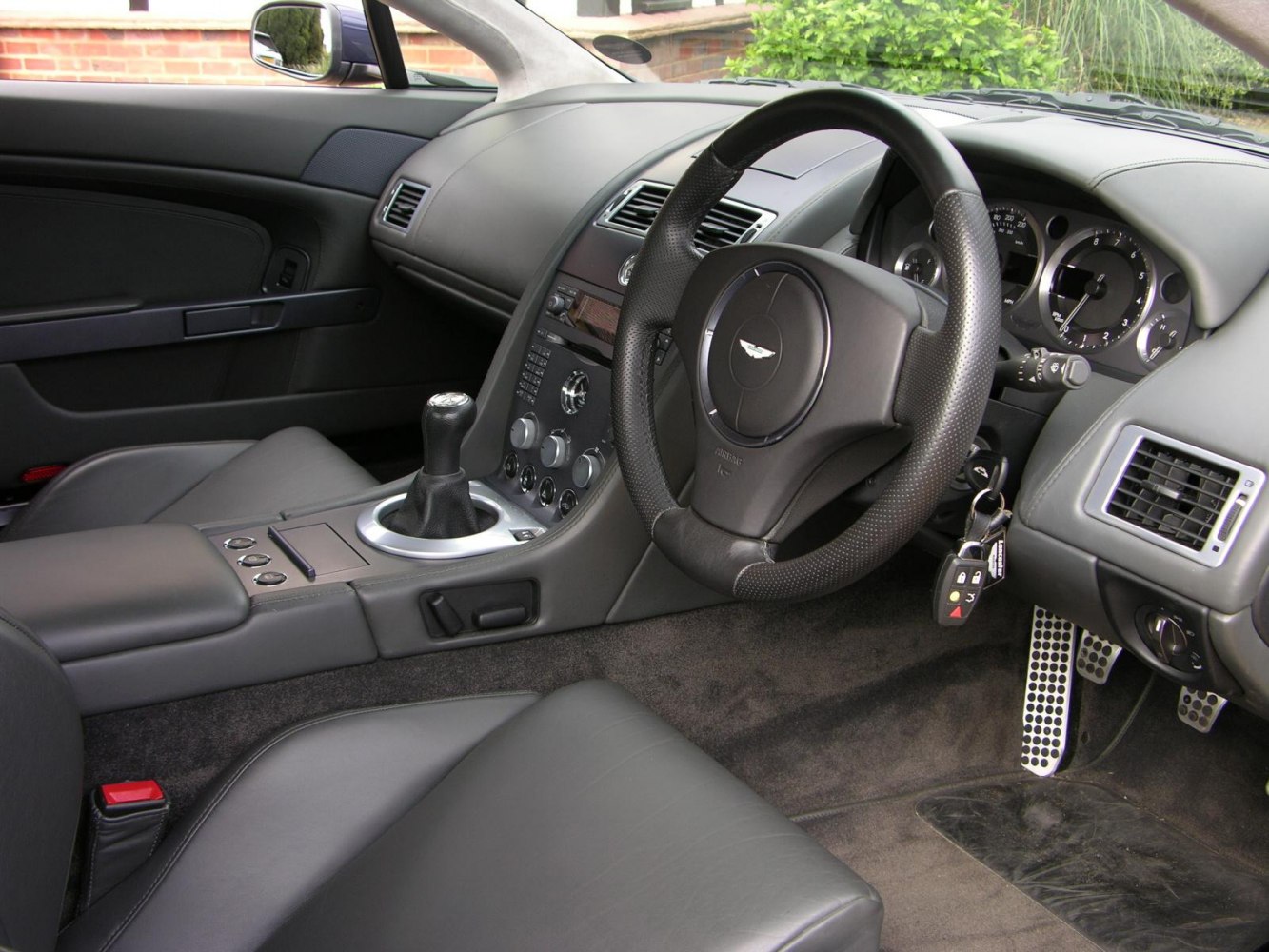 Luxury car interior with manual gear stick and analog gauges