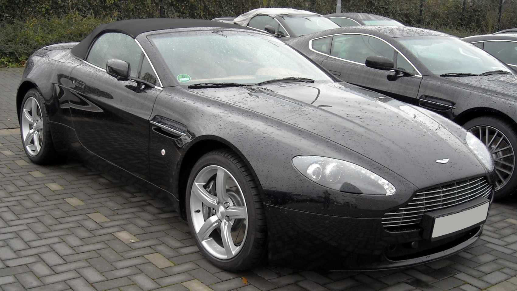 Black convertible with sleek body and alloy wheels