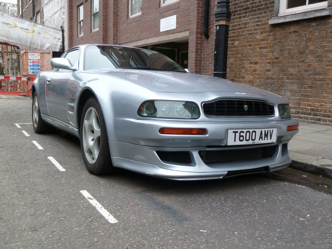 Silver 1990s sports coupe front side view with distinctive headlights