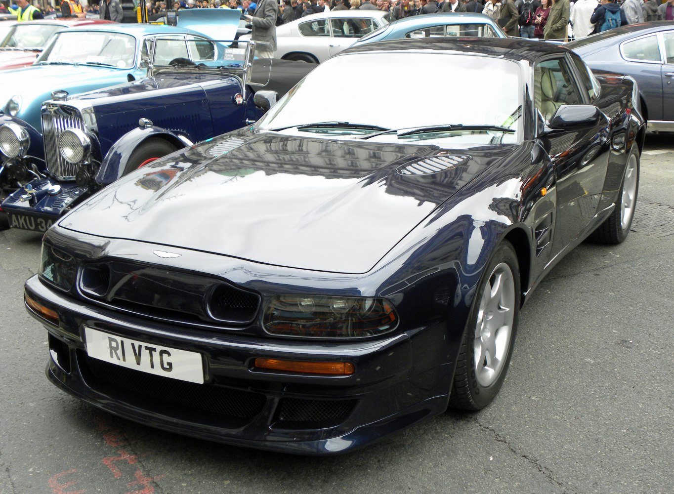 Sleek, aerodynamic sports coupe front with hood vents and alloy wheels
