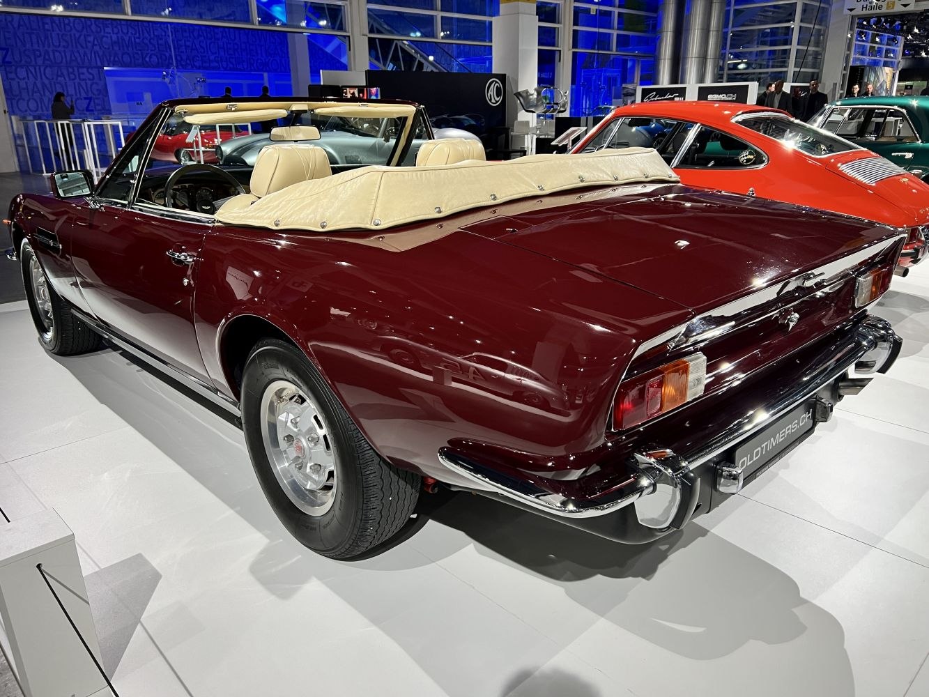 Convertible rear view with beige leather interior and chrome bumper