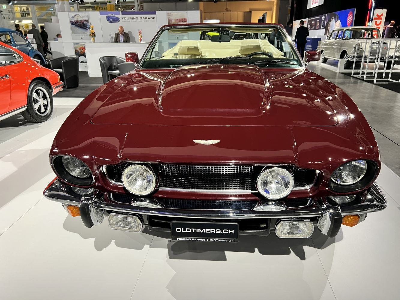 Classic front view with raised hood scoop, round headlights, and central fog lamps.