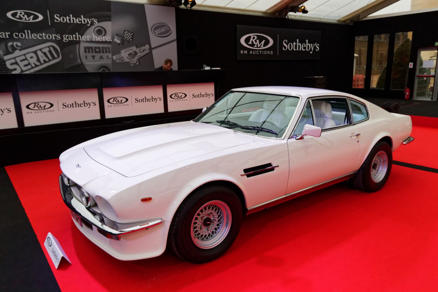 Vintage sports coupe with wire-spoke wheels and prominent hood scoop