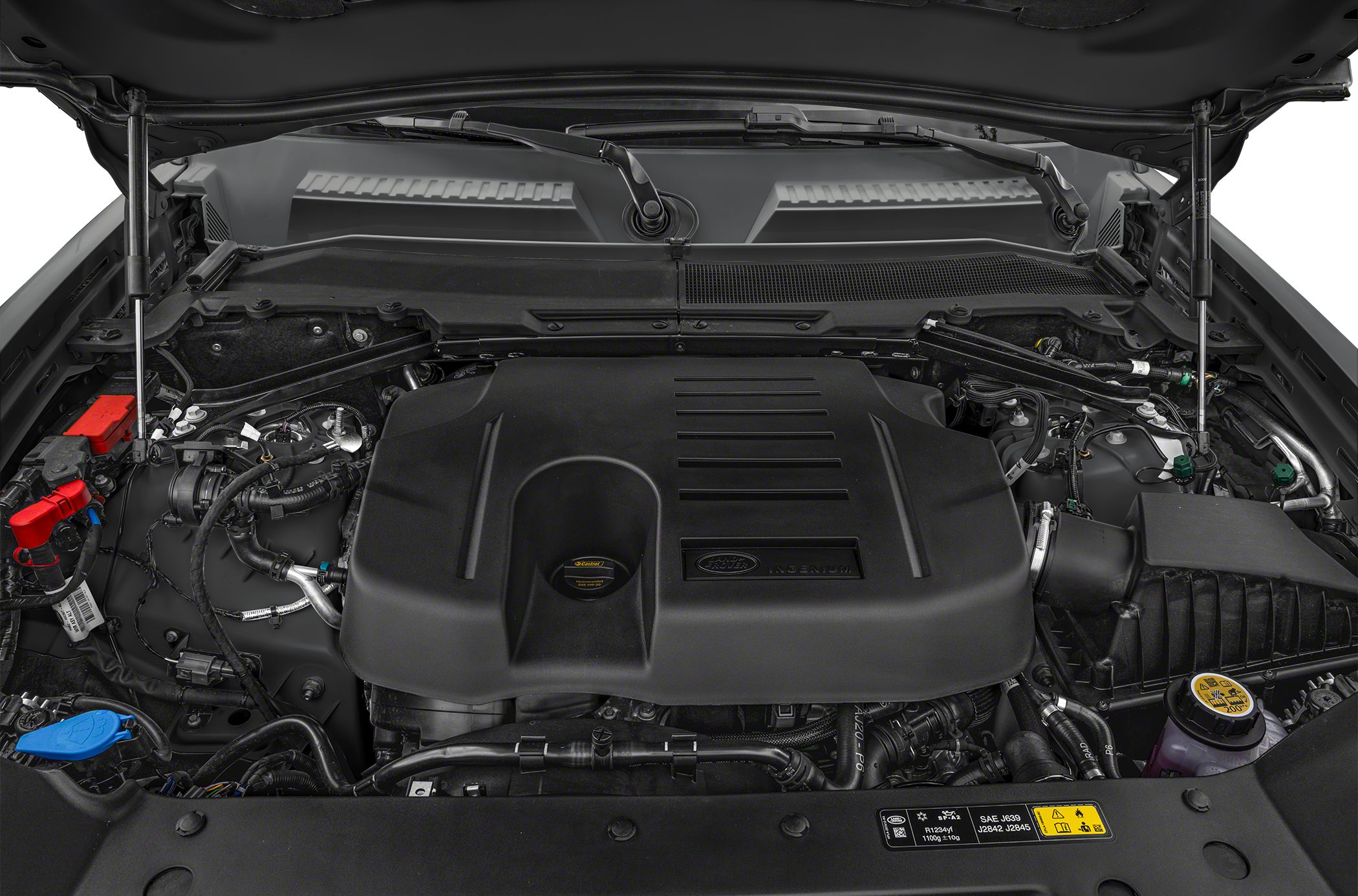 Engine bay with large black Ingenium engine cover and visible components