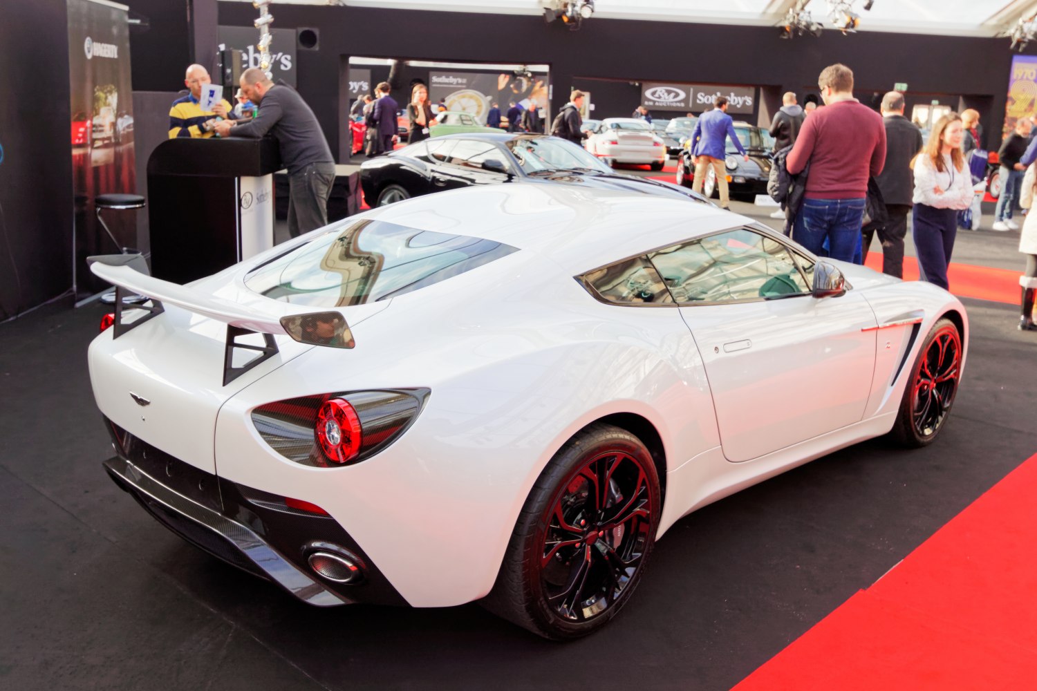 Rear view of sleek sports coupe with aerodynamic spoiler and black rims