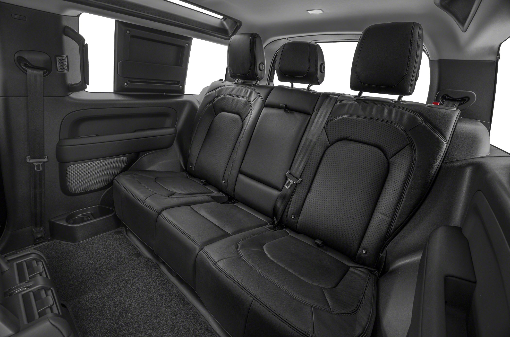 Black leather rear seats with integrated headrests and seat belts.