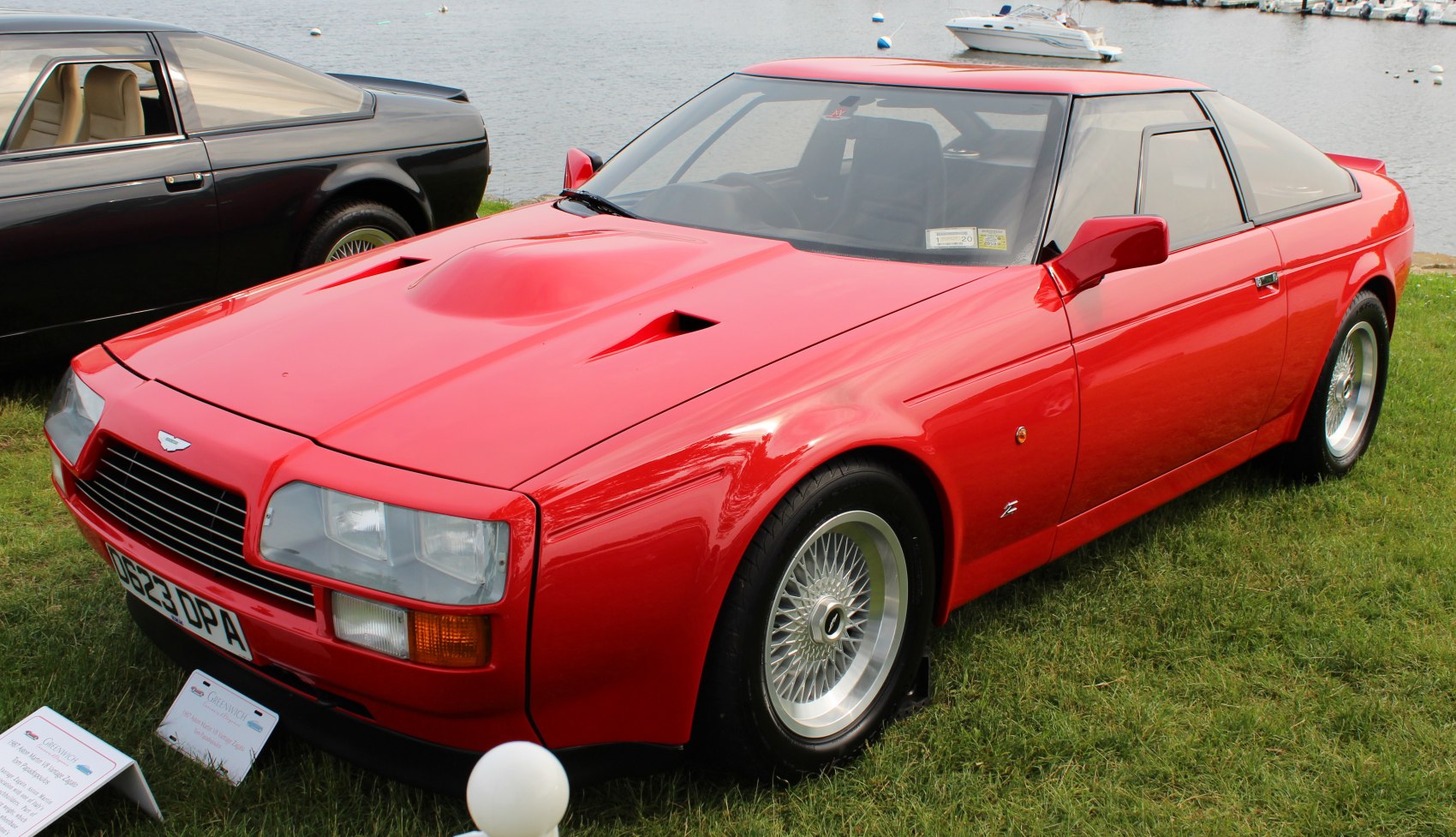 Red sports coupe with front hood vents and classic 1980s design