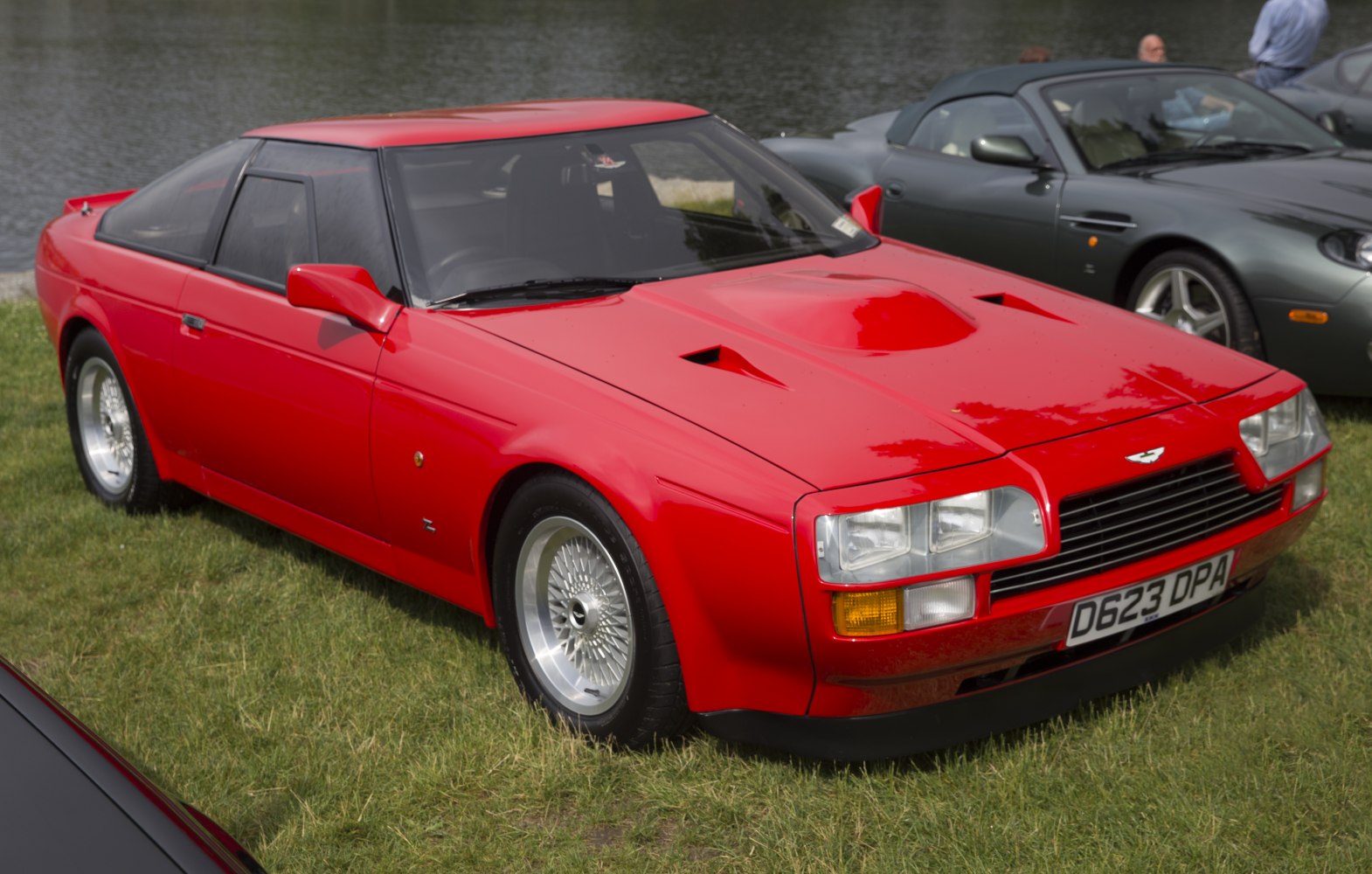 Red sports coupe with squared headlights and vented hood