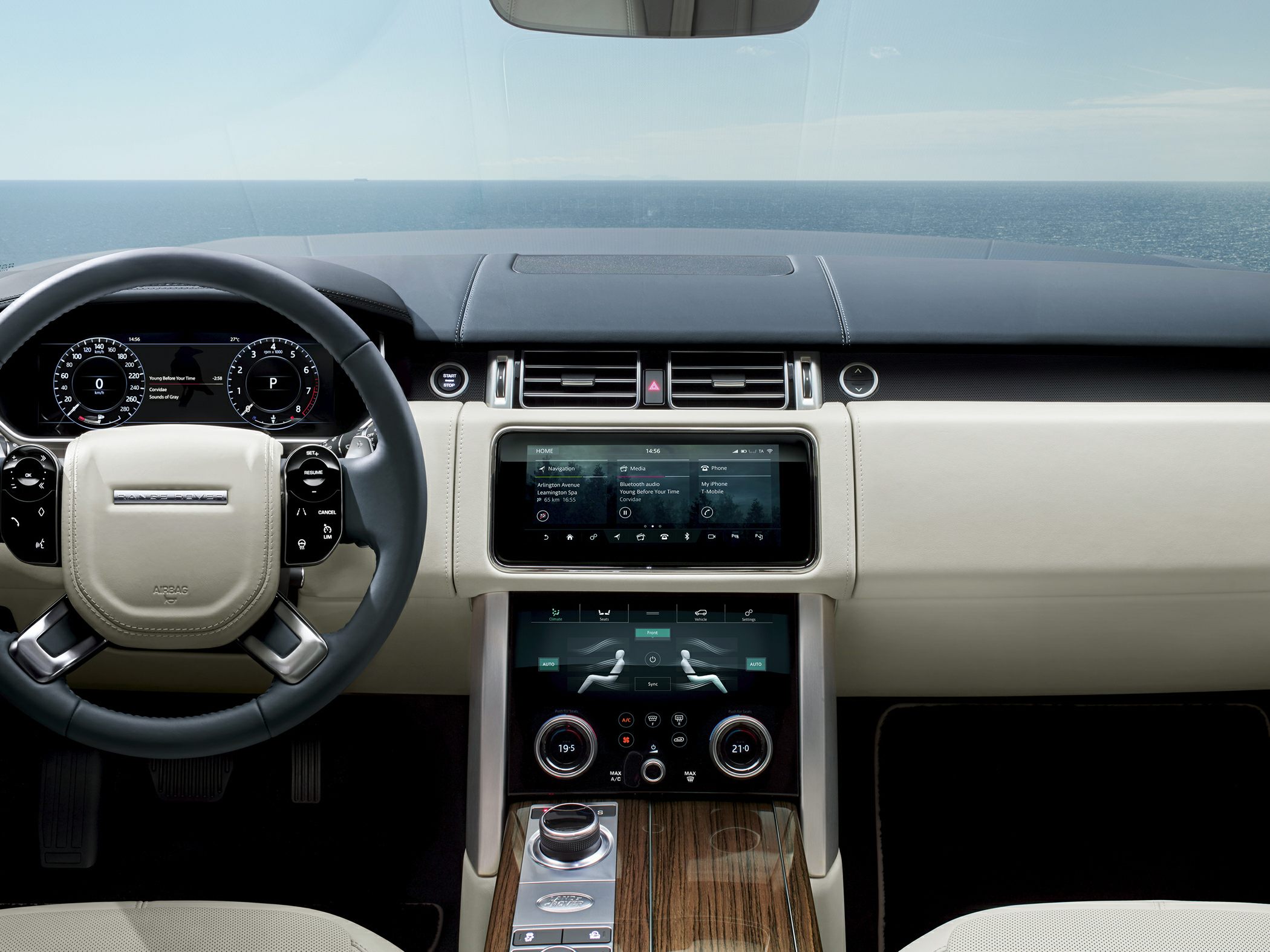 Luxury SUV dashboard with digital displays and wood trim center console