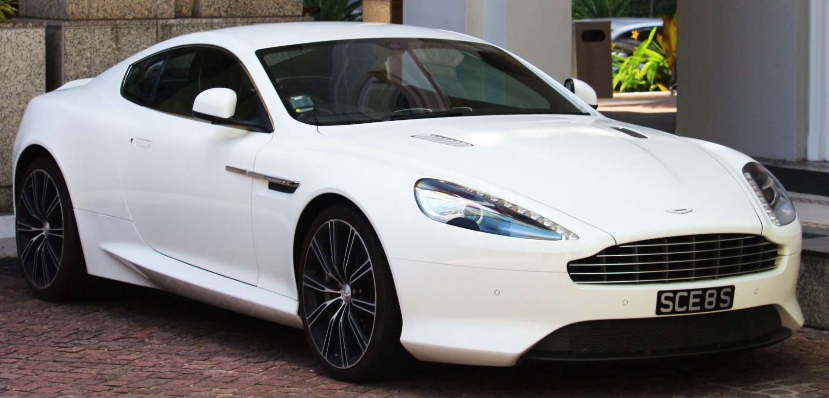 Sleek white coupe with aerodynamic body and distinctive headlights