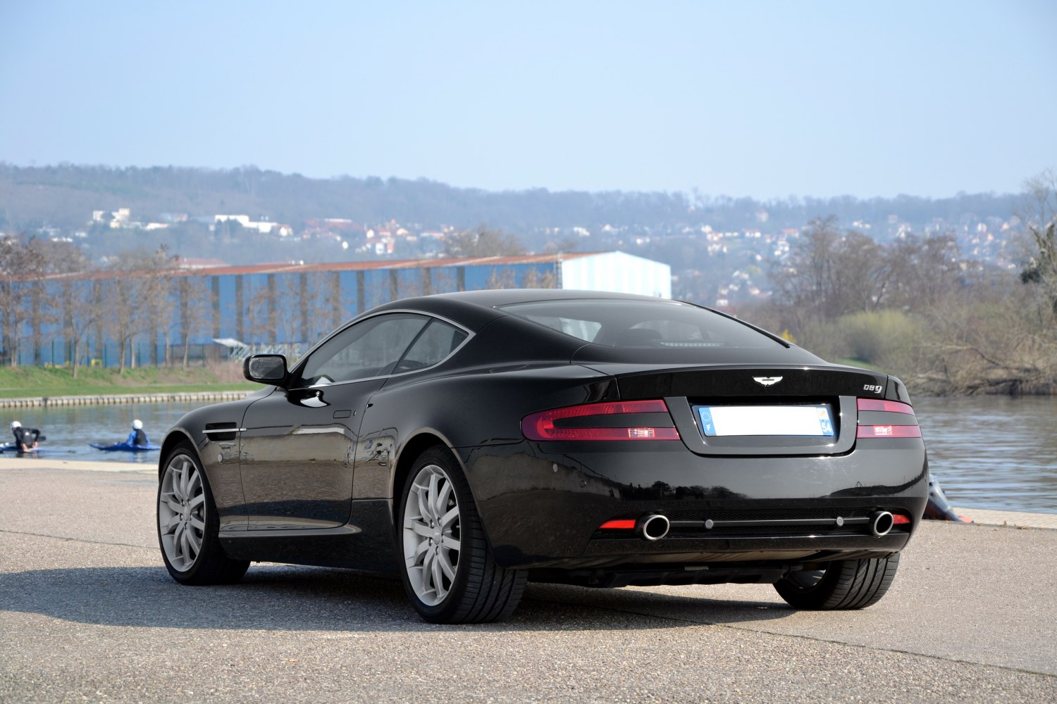 Black luxury coupe rear with tail lights and dual exhausts