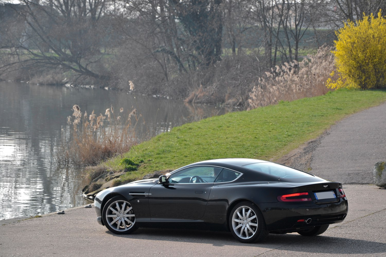 Sleek black coupe with alloy wheels and distinctive rear lights