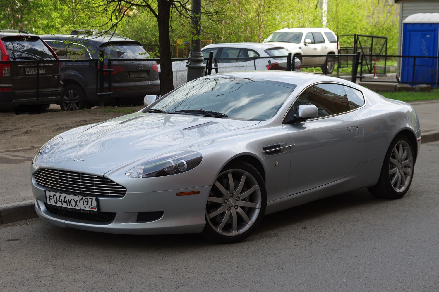 Silver luxury coupe front side with alloy wheels and aerodynamic design