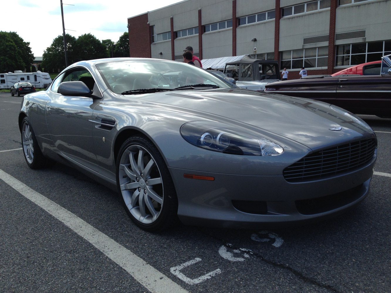 Front side view of a sleek coupe with distinct headlights and alloy wheels