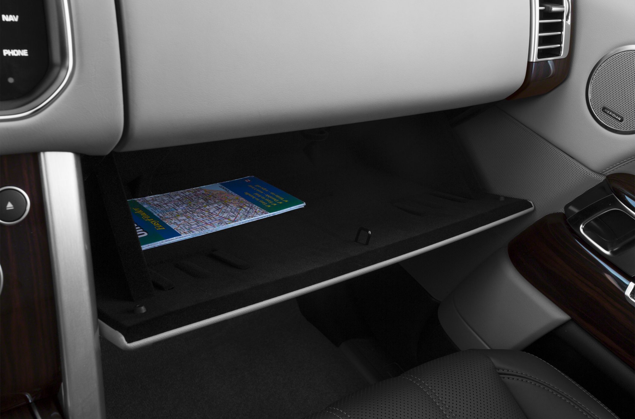 Spacious glove compartment with a map inside.
