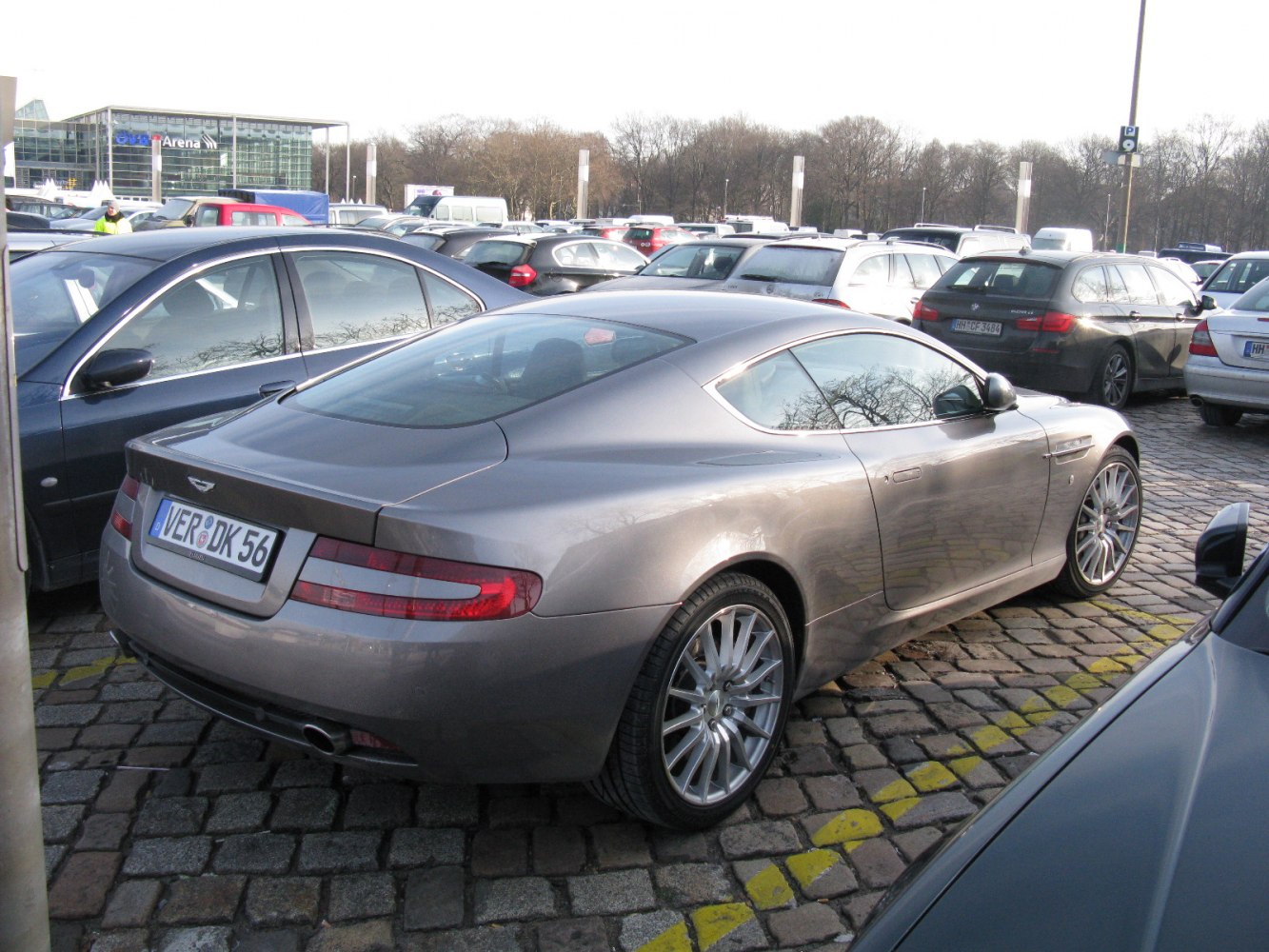Rear and side view of a sleek luxury coupe with smooth curves and distinctive tail lights.