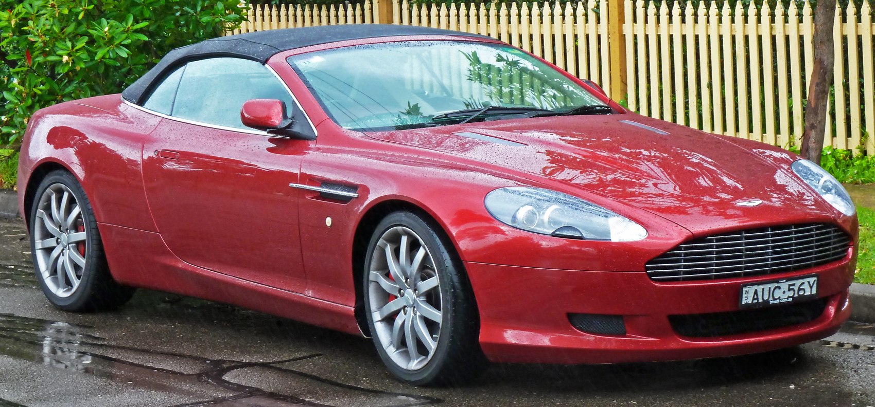 Red convertible with visible front side, sleek body, alloy wheels