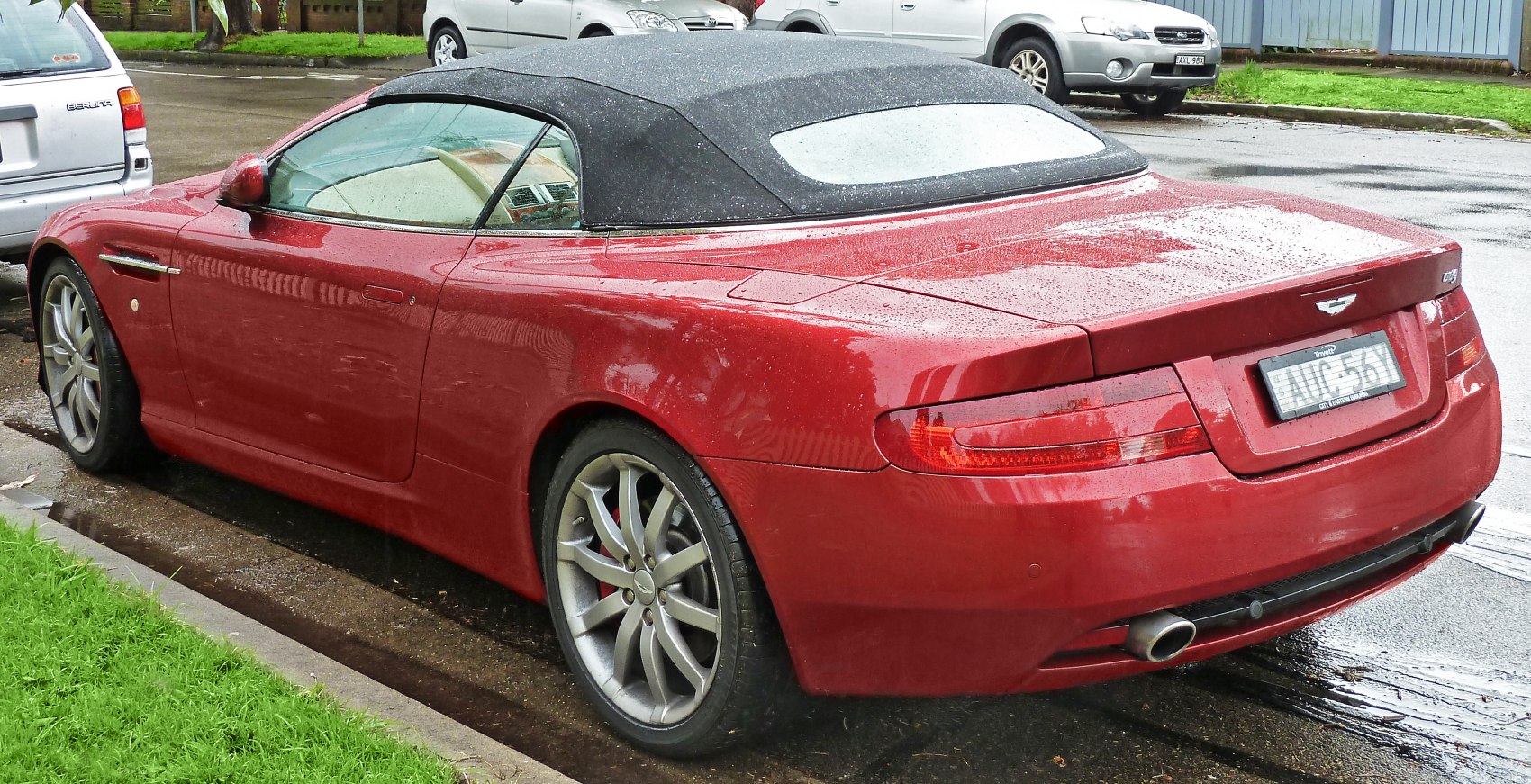 Convertible with black soft top and alloy wheels.
