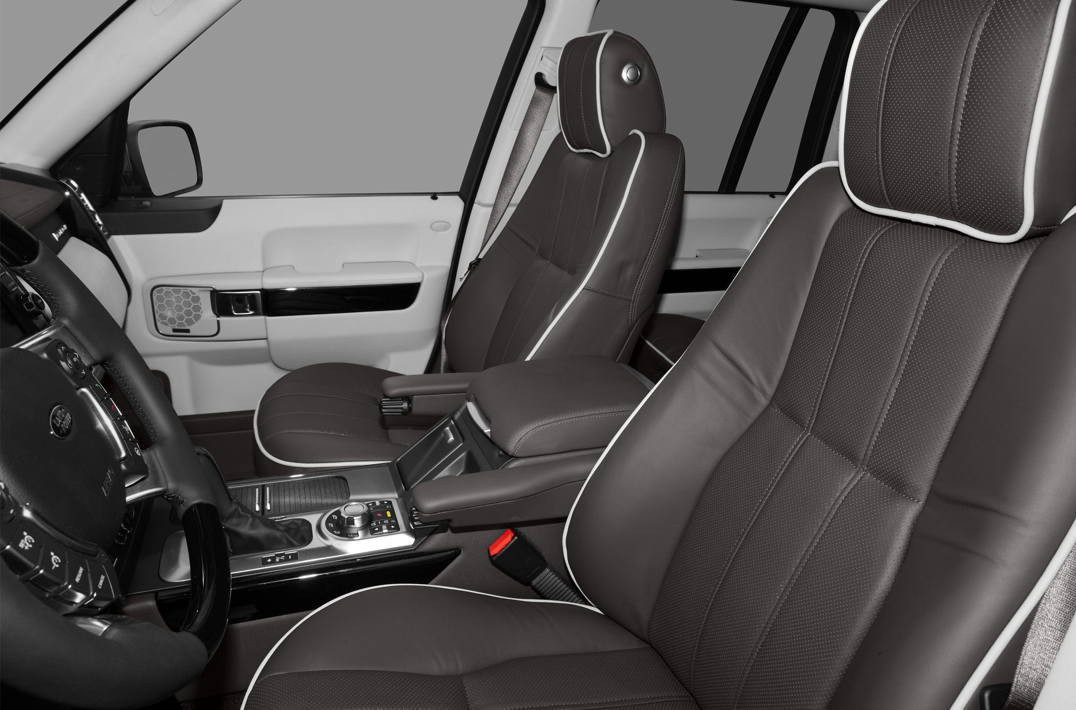 Plush seats with contrast piping and detailed central console design.