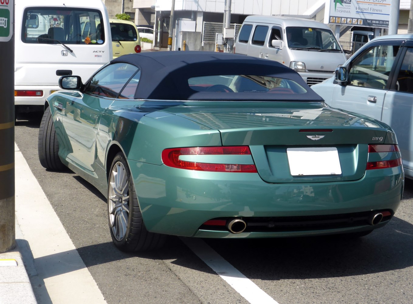 Rear view of convertible with soft top and dual exhaust