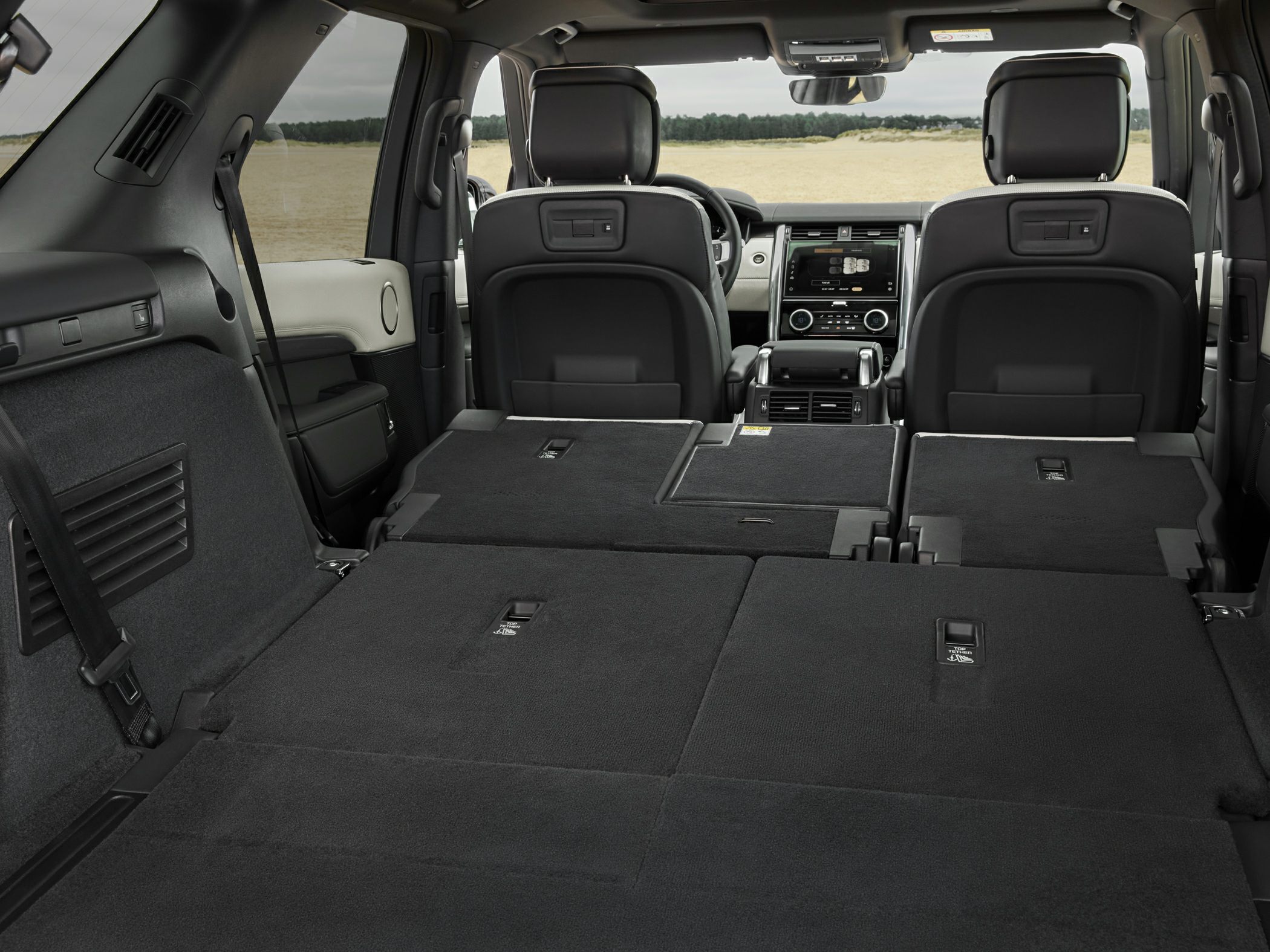 Folded rear seats creating flat cargo space in a premium SUV interior
