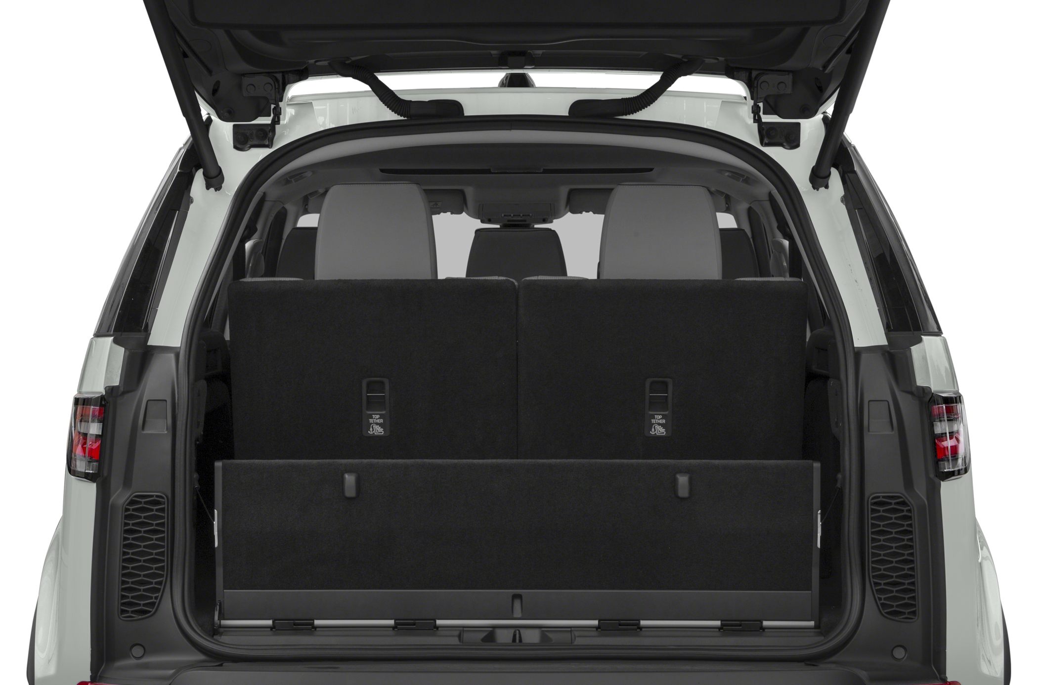 Open rear cargo area with folded third-row seats and visible seat headrests