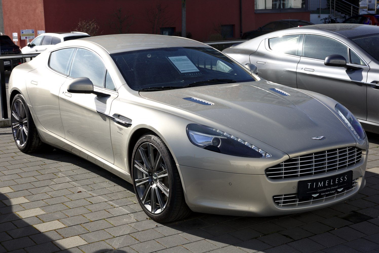 Front side view with vented hood and alloy wheels