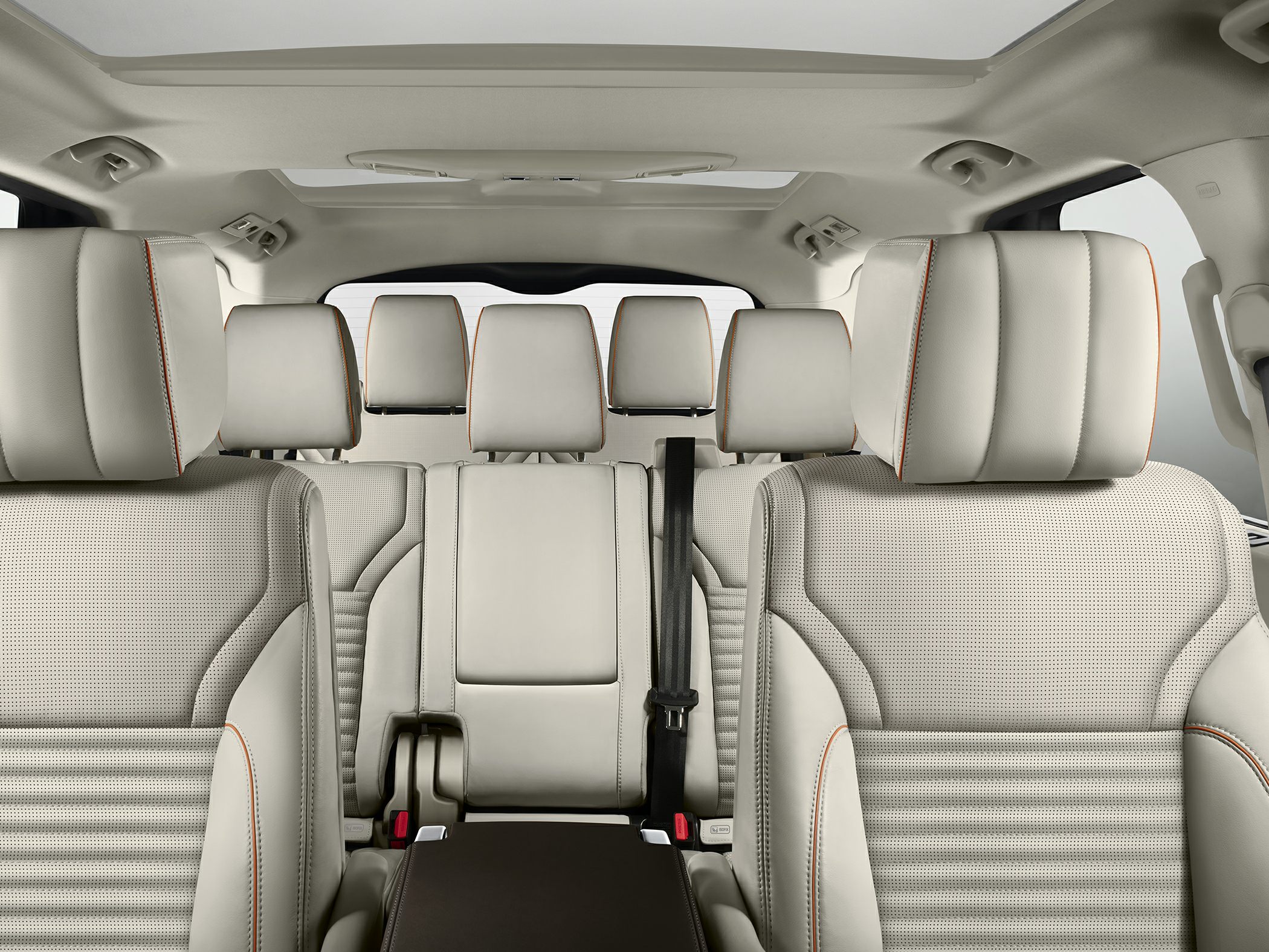 Spacious beige leather seats with multiple headrests and panoramic roof