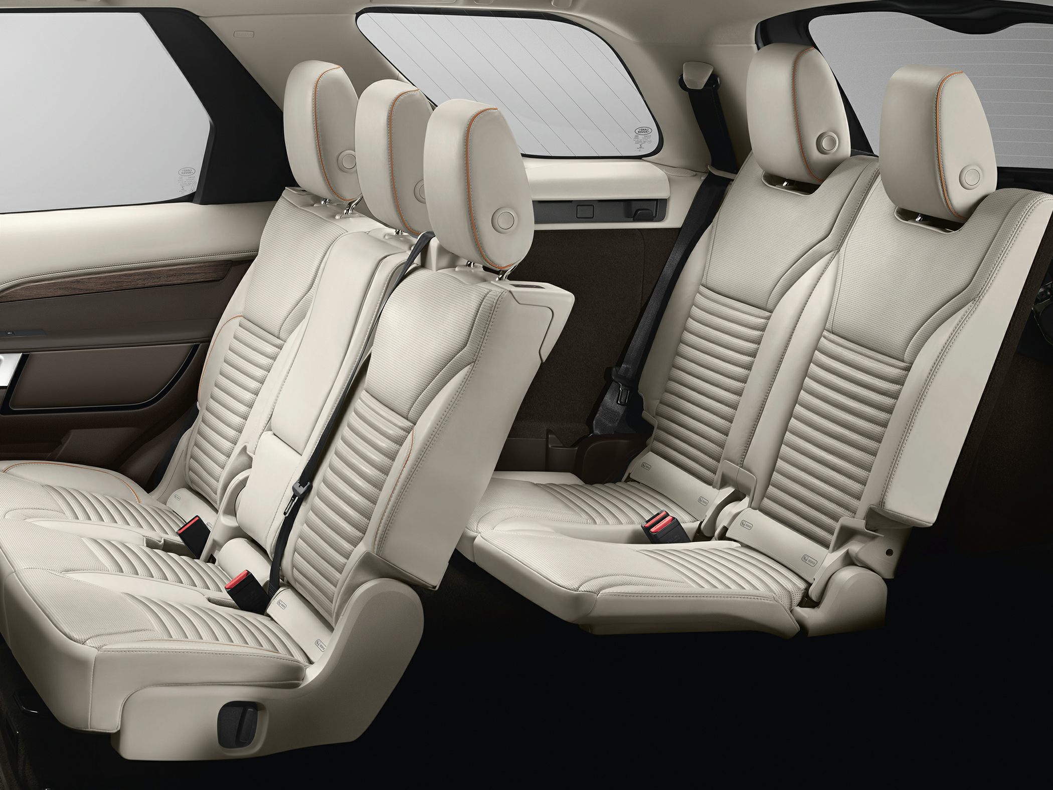 Premium beige leather rear seats with headrests and detailed stitching