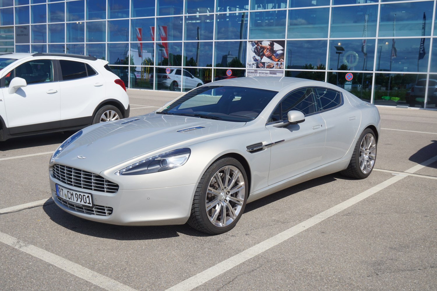 Silver 4-door luxury sports sedan with distinctive front grille and alloy wheels