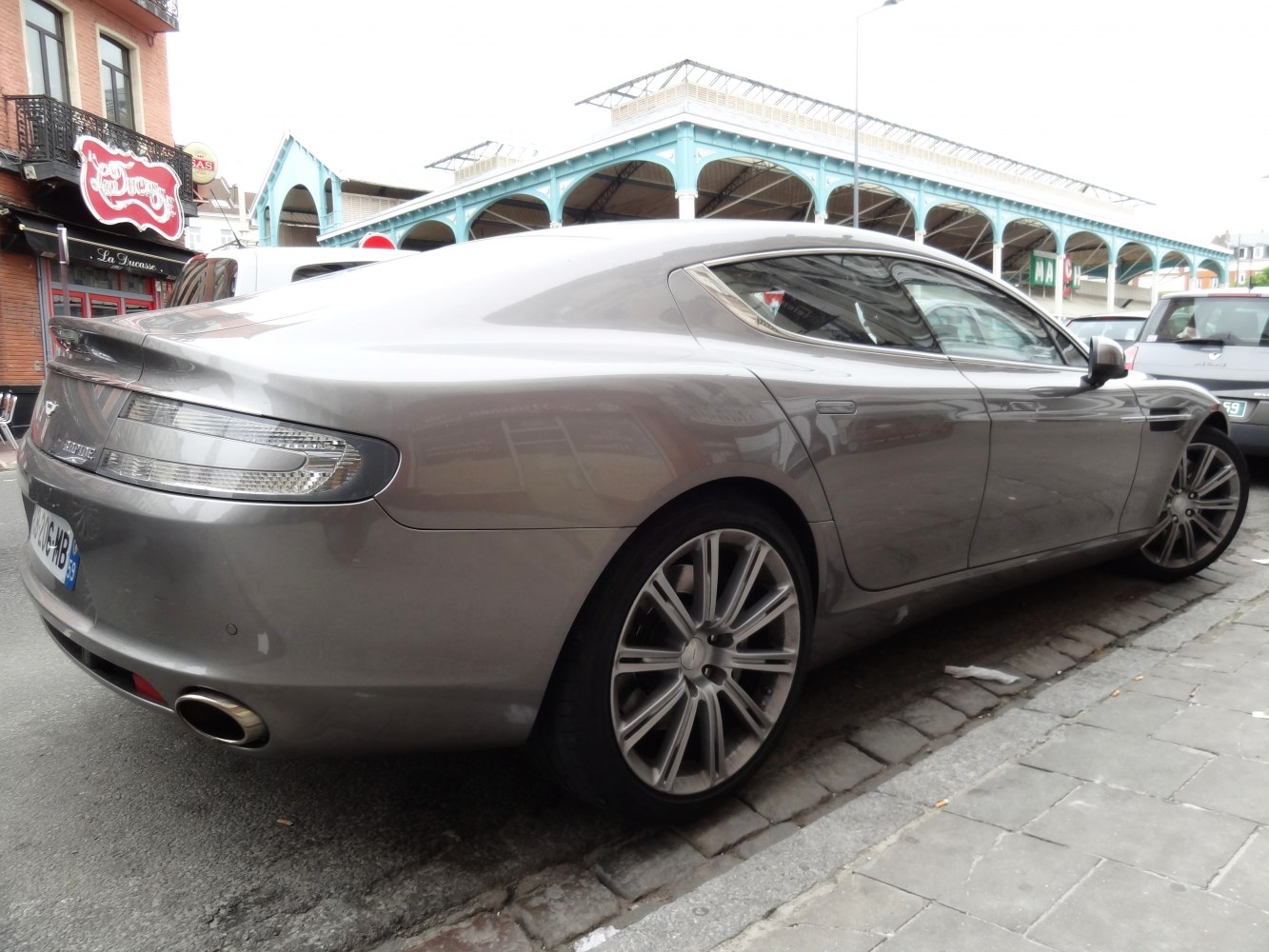 Rear side profile of sleek luxury sports sedan with alloy wheels and dual exhaust tip