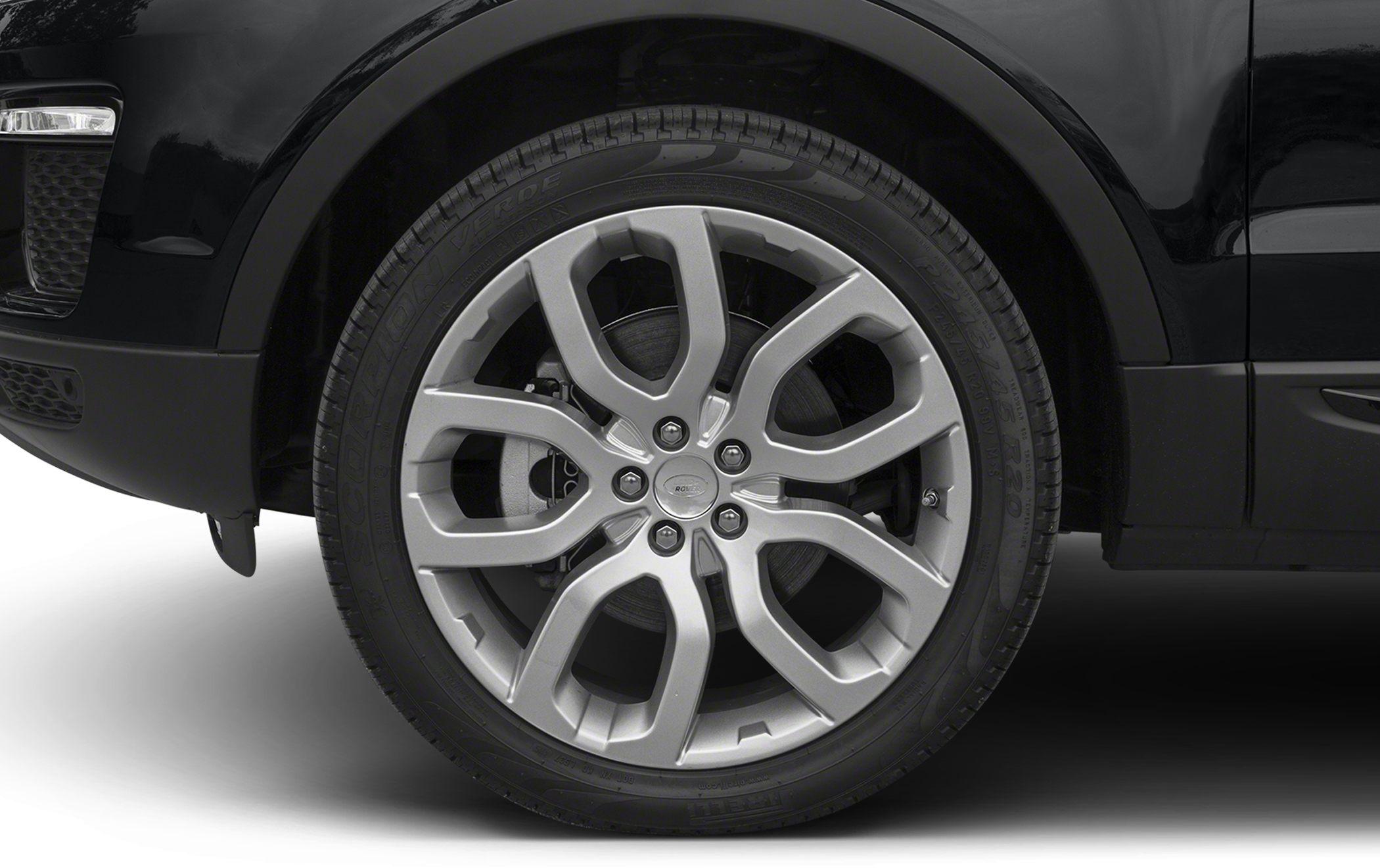 Closeup of multi-spoke alloy wheel and tire on black SUV.