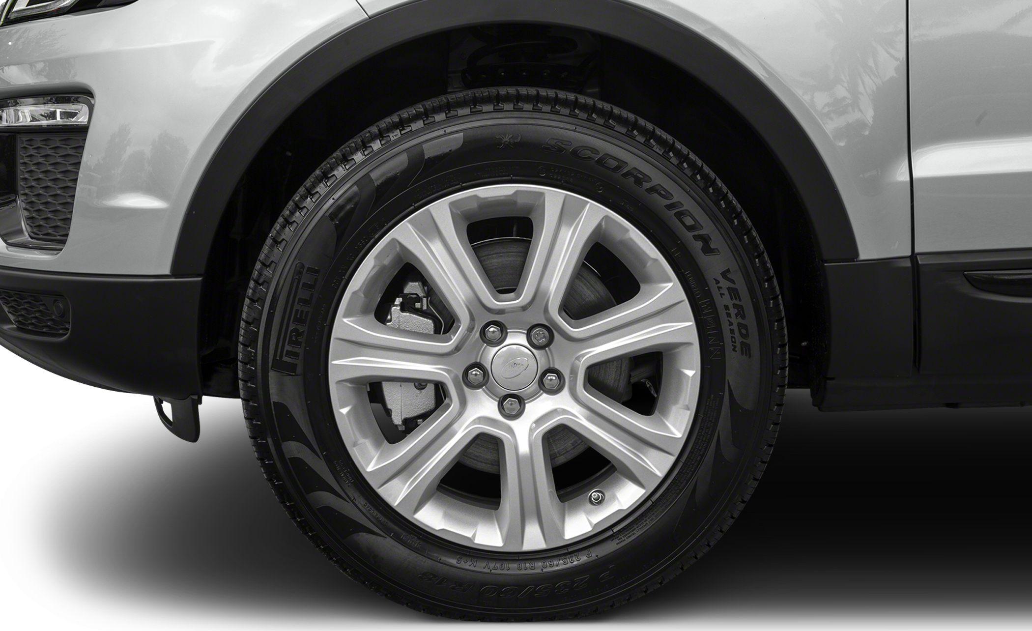 Close-up of alloy wheel with branded tire on SUV