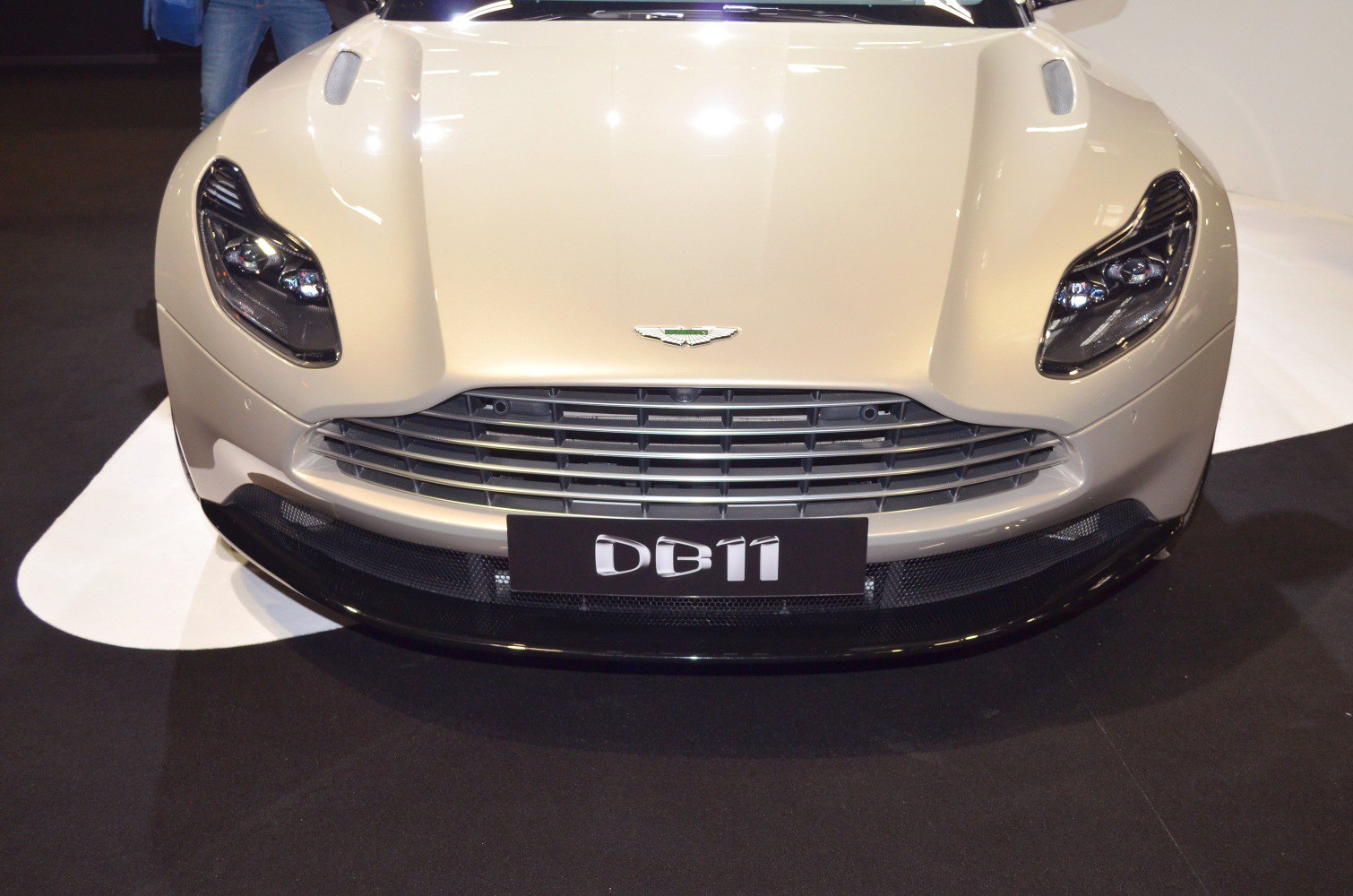 Front grille and sleek headlights of a modern luxury sports car.