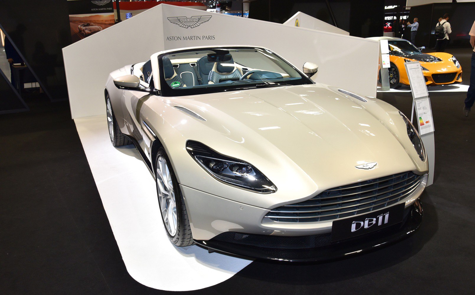 Front view of a convertible sports car with sleek headlights and open roof