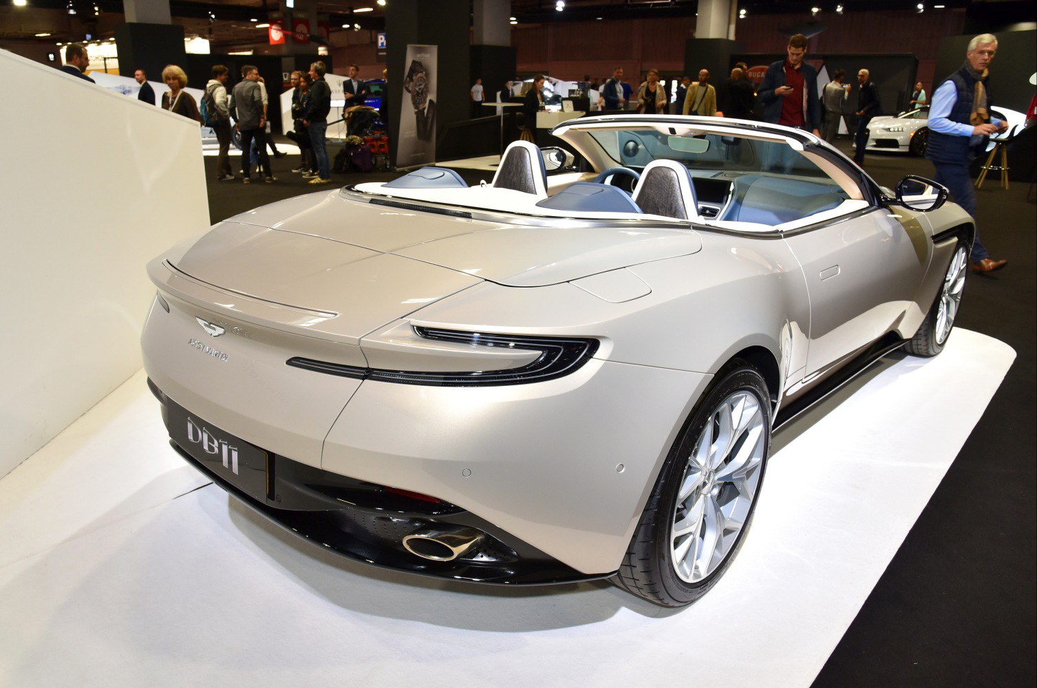 Rear view of sleek luxury convertible with modern taillights and dual exhaust.