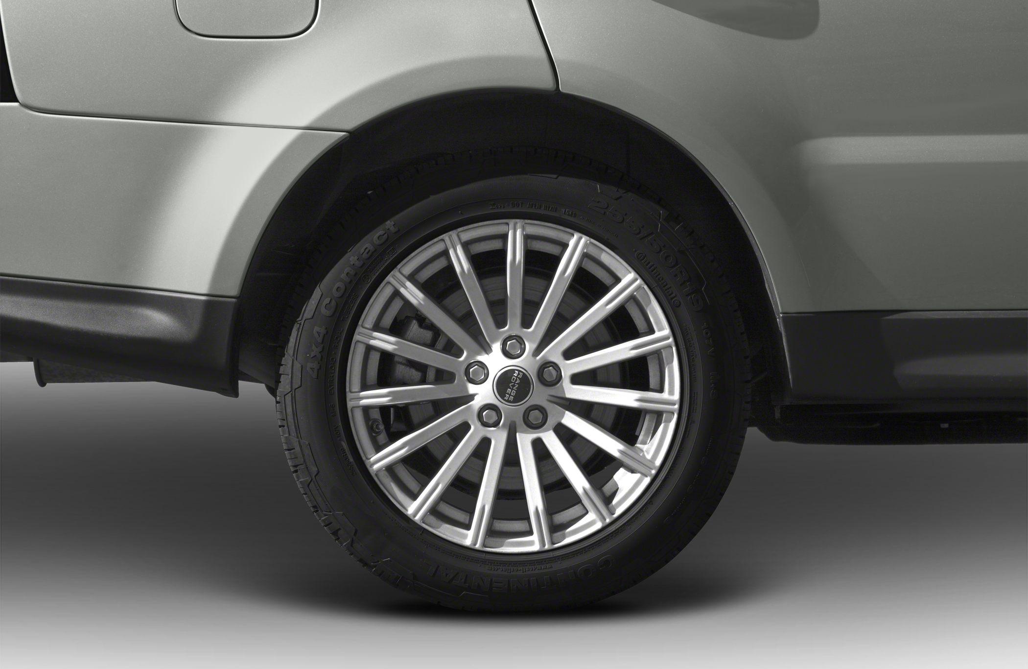 Close-up of 16-spoke alloy wheel and tire on SUV