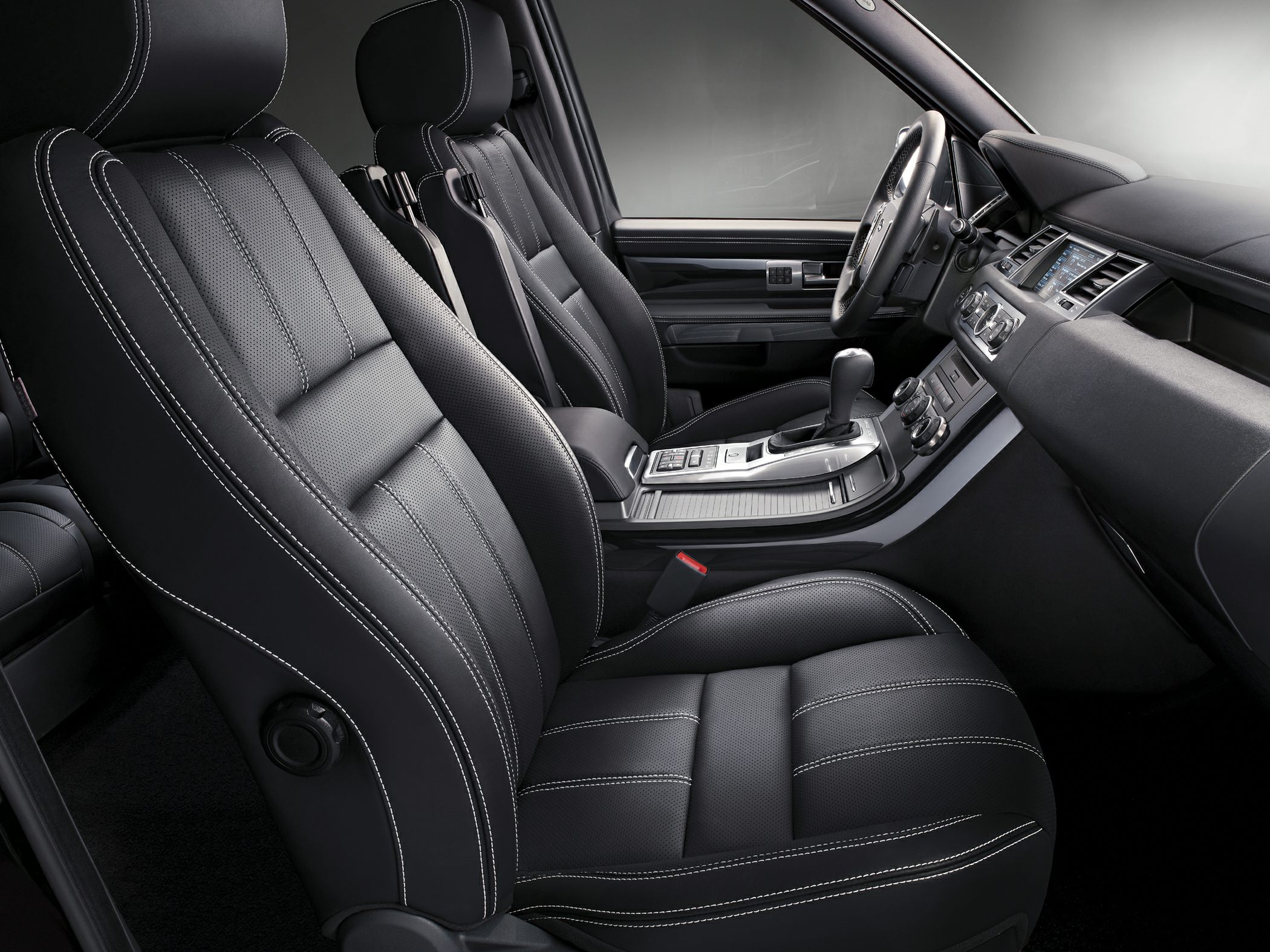 Black leather seats with white stitching and modern center console layout