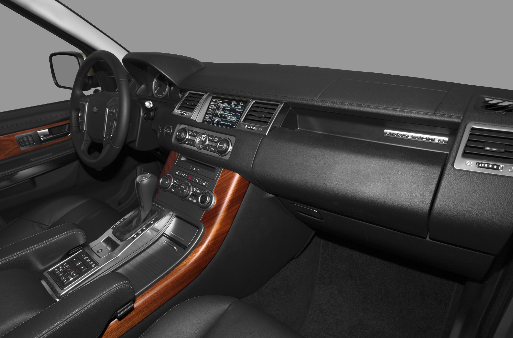 Luxury SUV interior with wood trim, touchscreen, and ergonomic controls