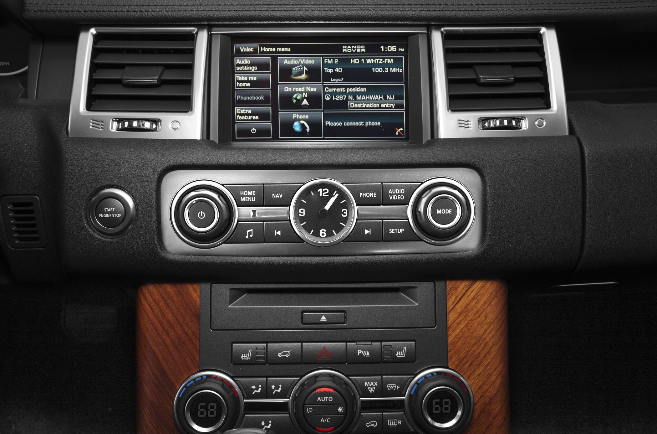 Infotainment screen with navigation and analog clock on luxury dashboard