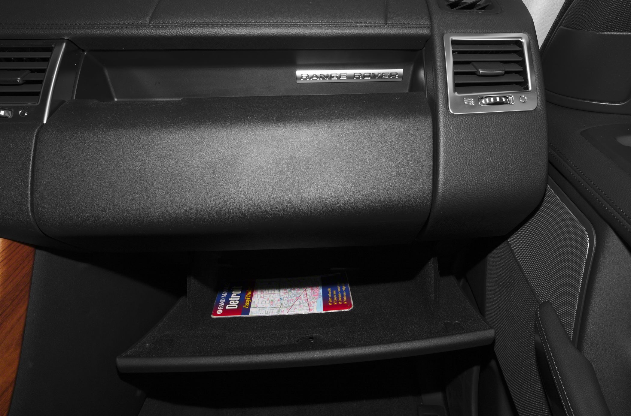 Dashboard with open glove compartment and map inside