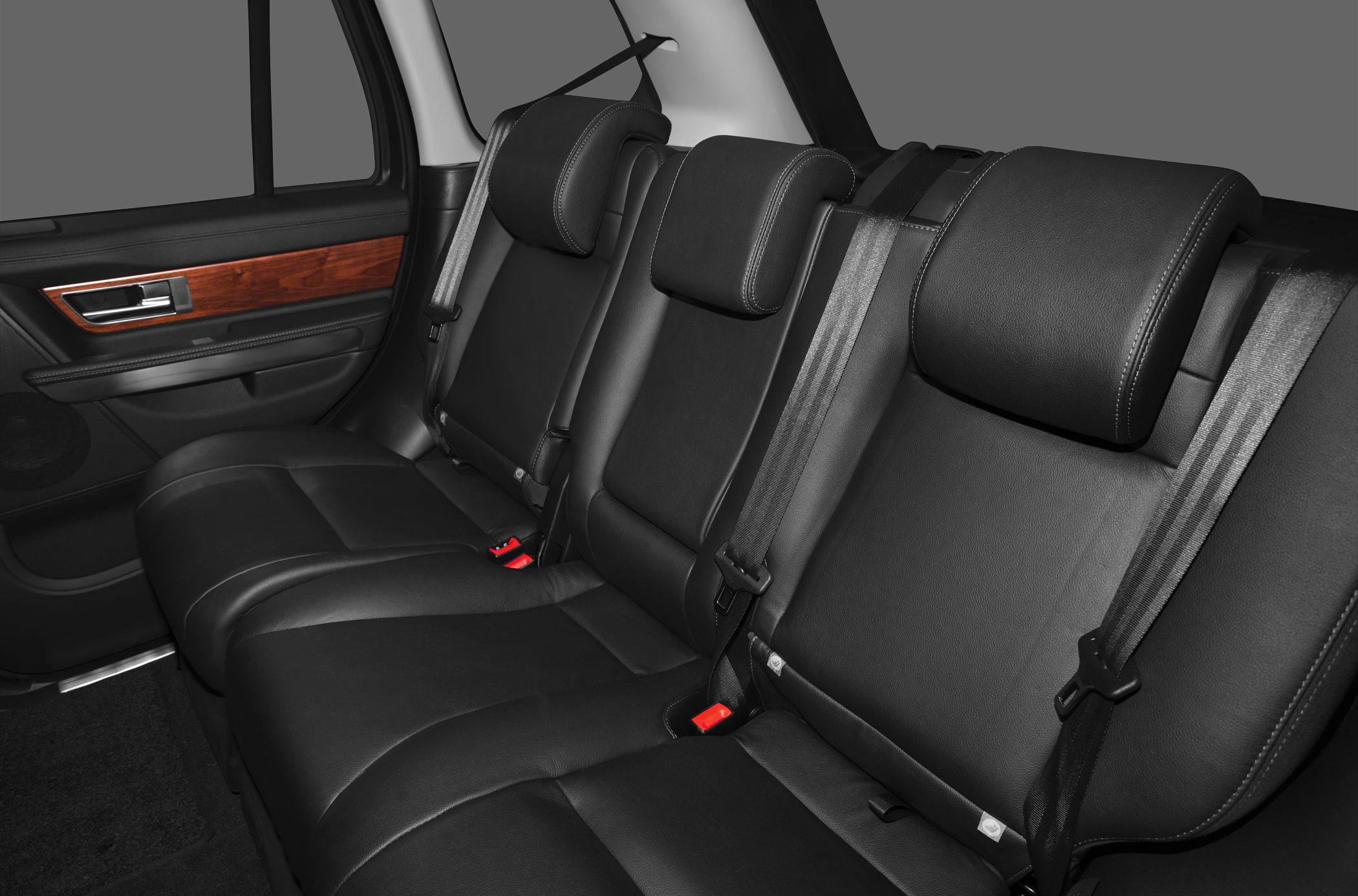 Black leather rear seats with adjustable headrests and wood-trim door panel