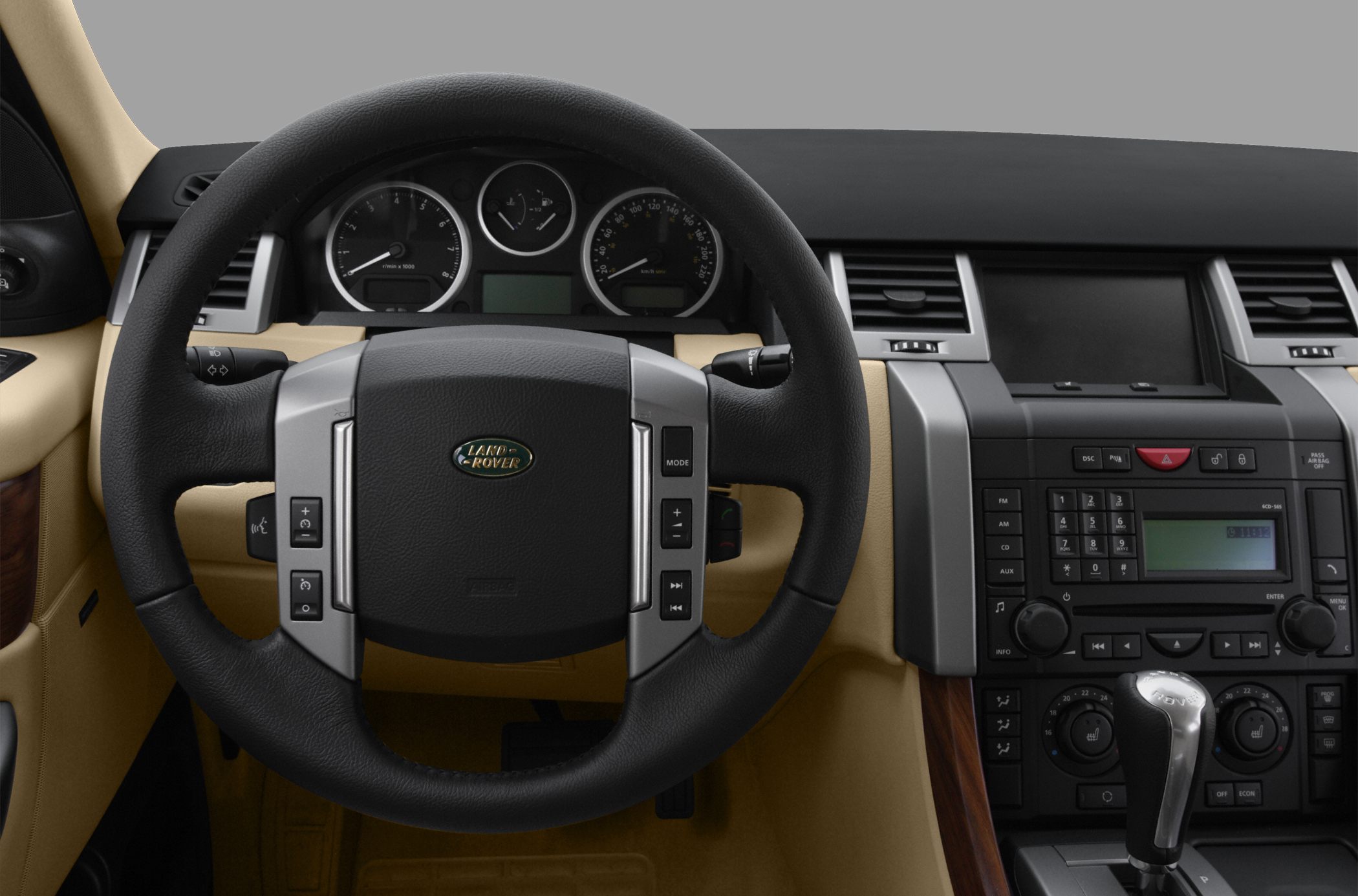 Steering wheel with control buttons, instrument cluster, and central console controls