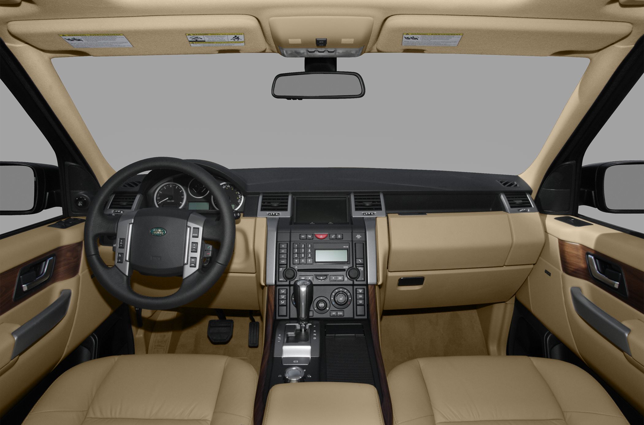 Beige leather interior with detailed dashboard and multifunction steering wheel.